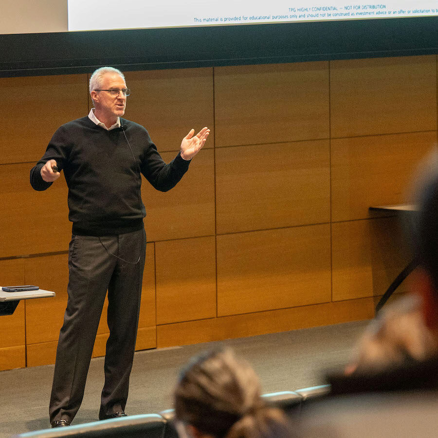 A speaker mid-lecture while addressing the audience