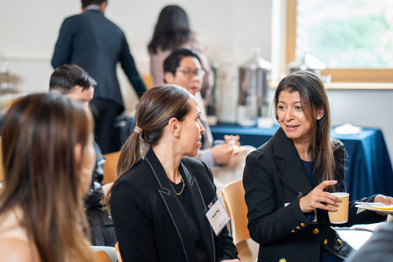 Conference attendees speaking with each other over coffee