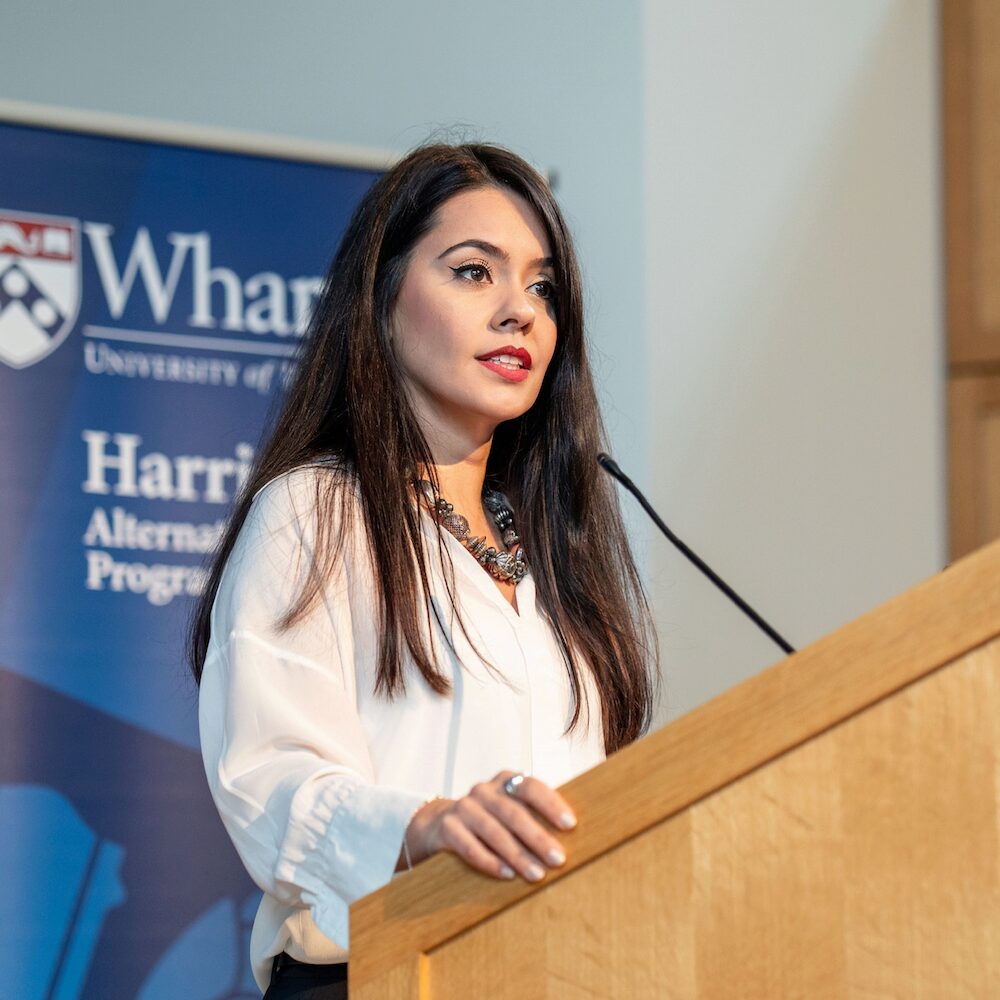 A person speaks from a podium
