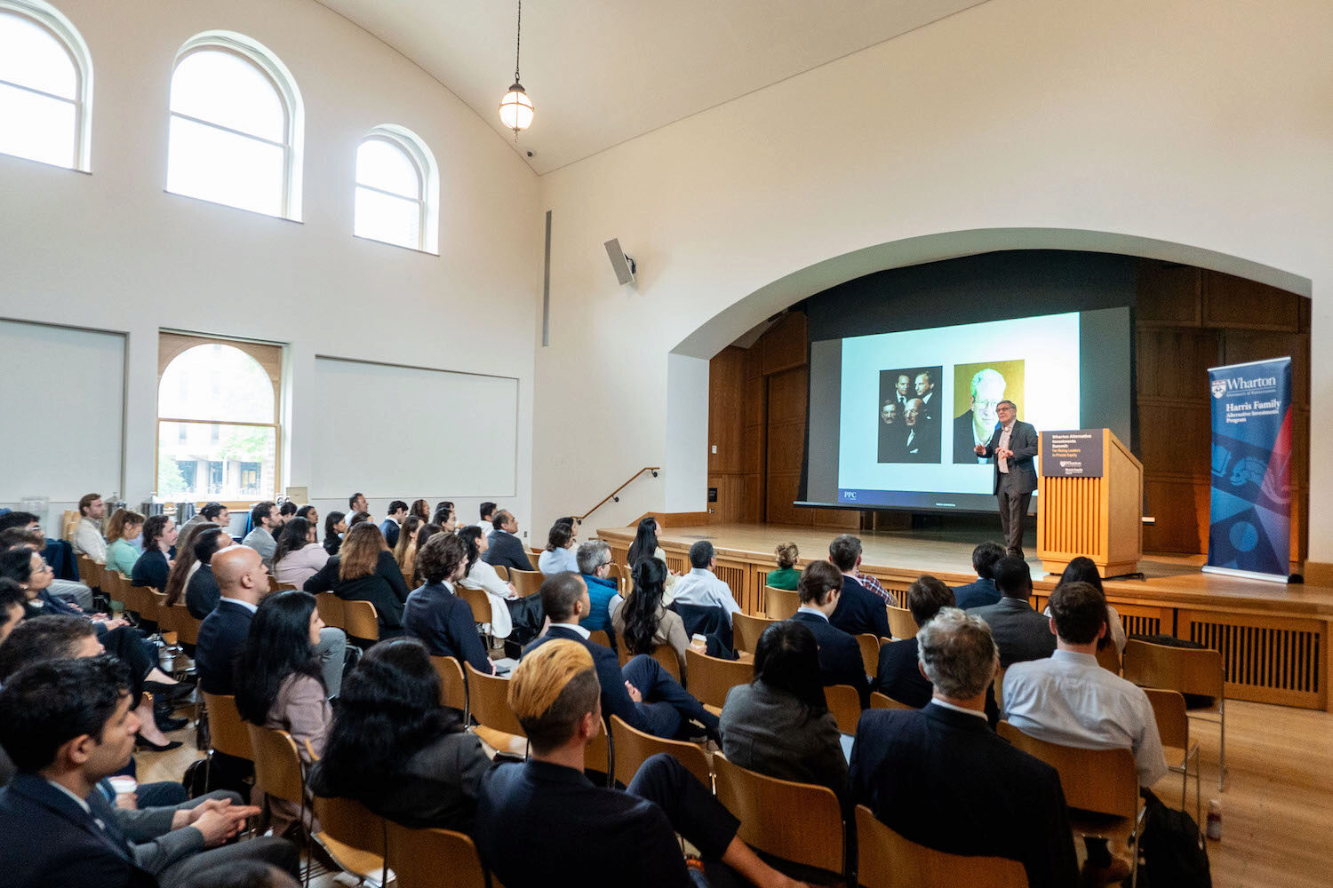 An audience watches a presentation
