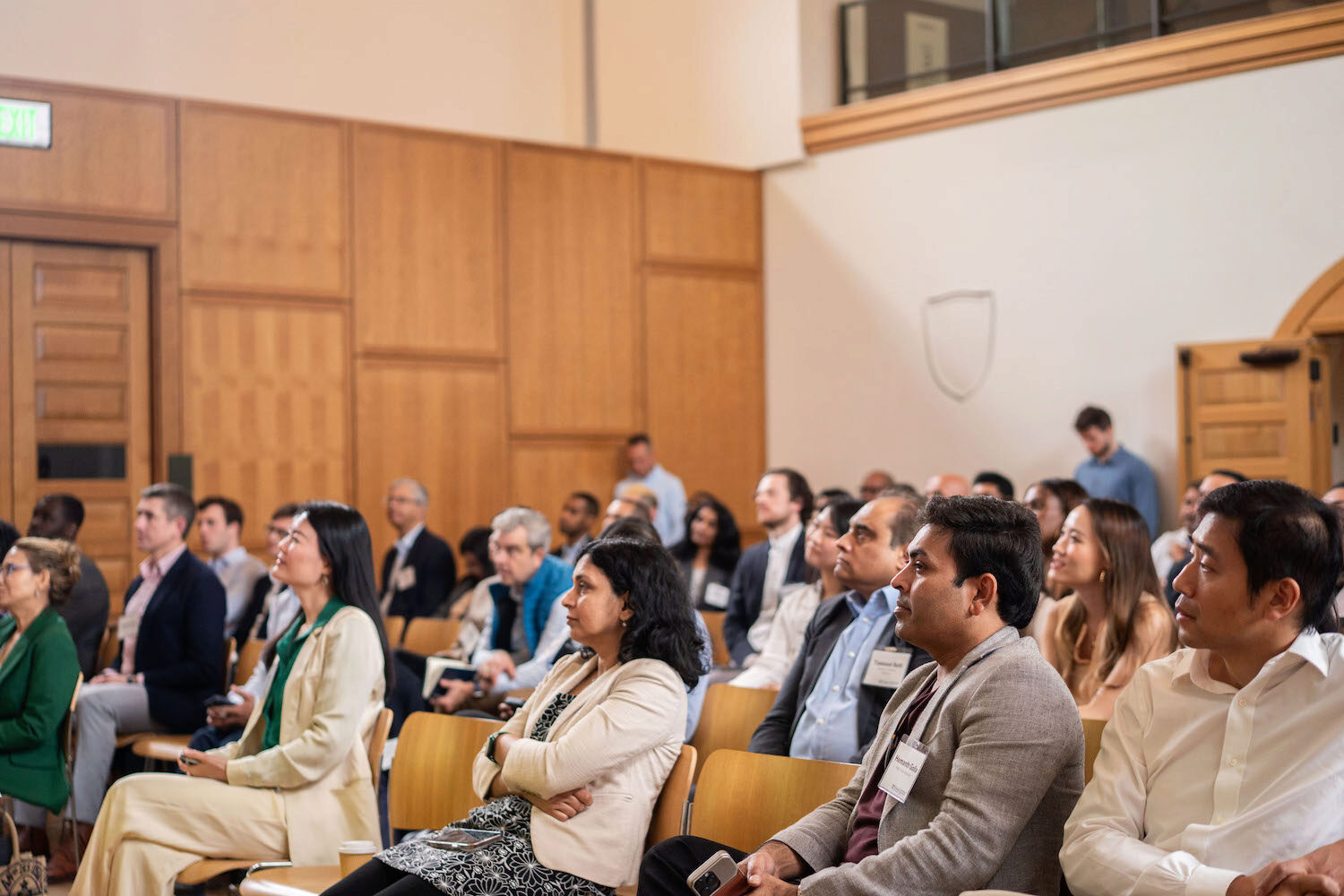 A seated audience watches a presentation