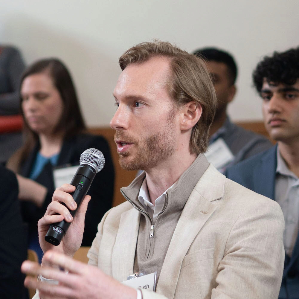 A person speaks into a microphone