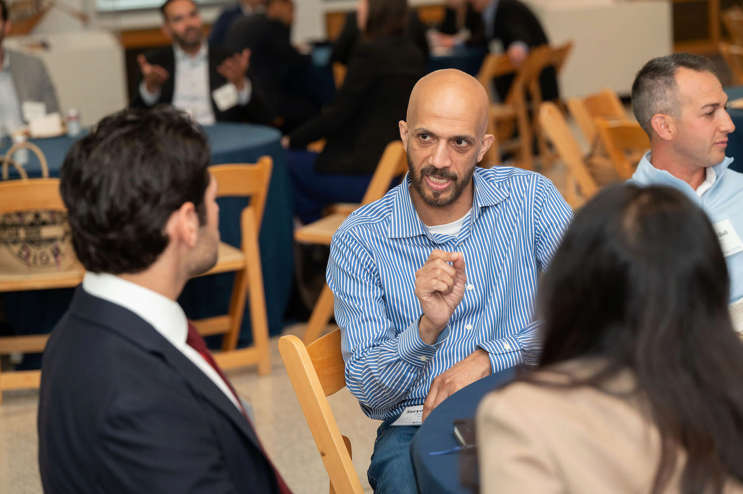 People speaking and networking at a conference