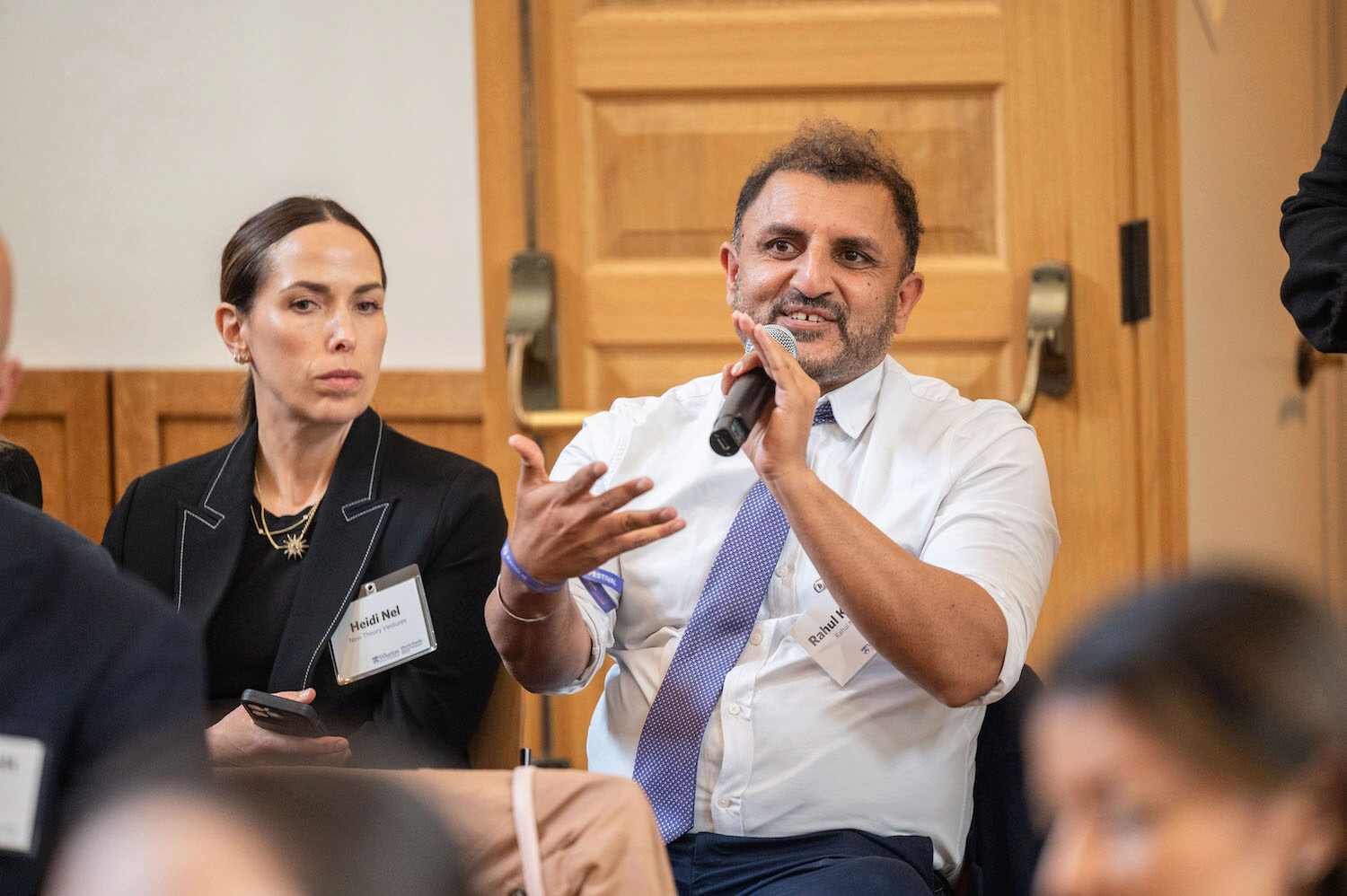 A person asks a question into a microphone