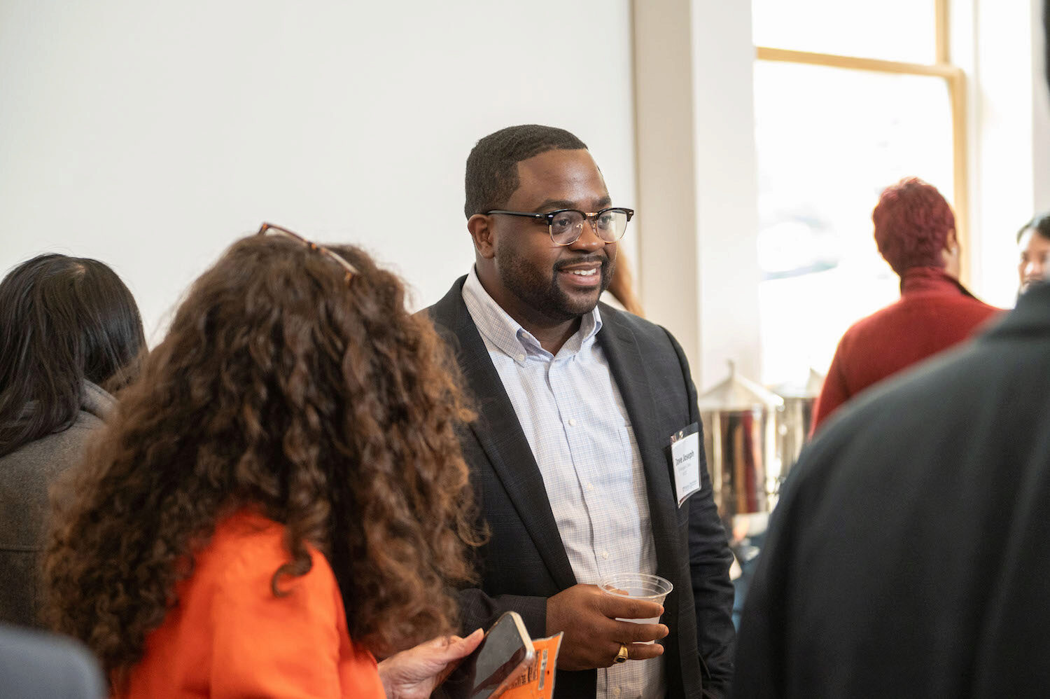 Conference attendees in conversation during a coffee break