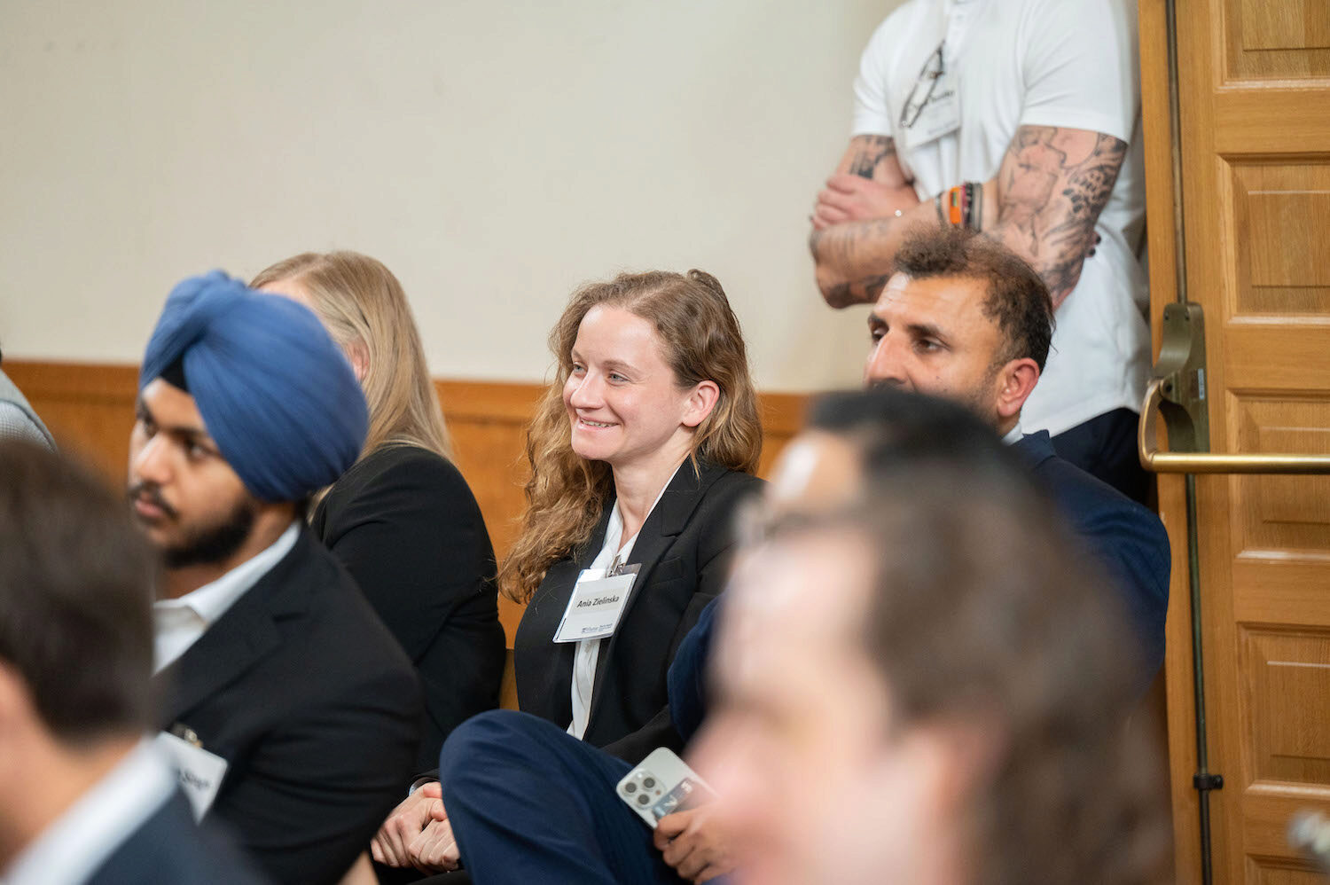 Audience members watch a presentation