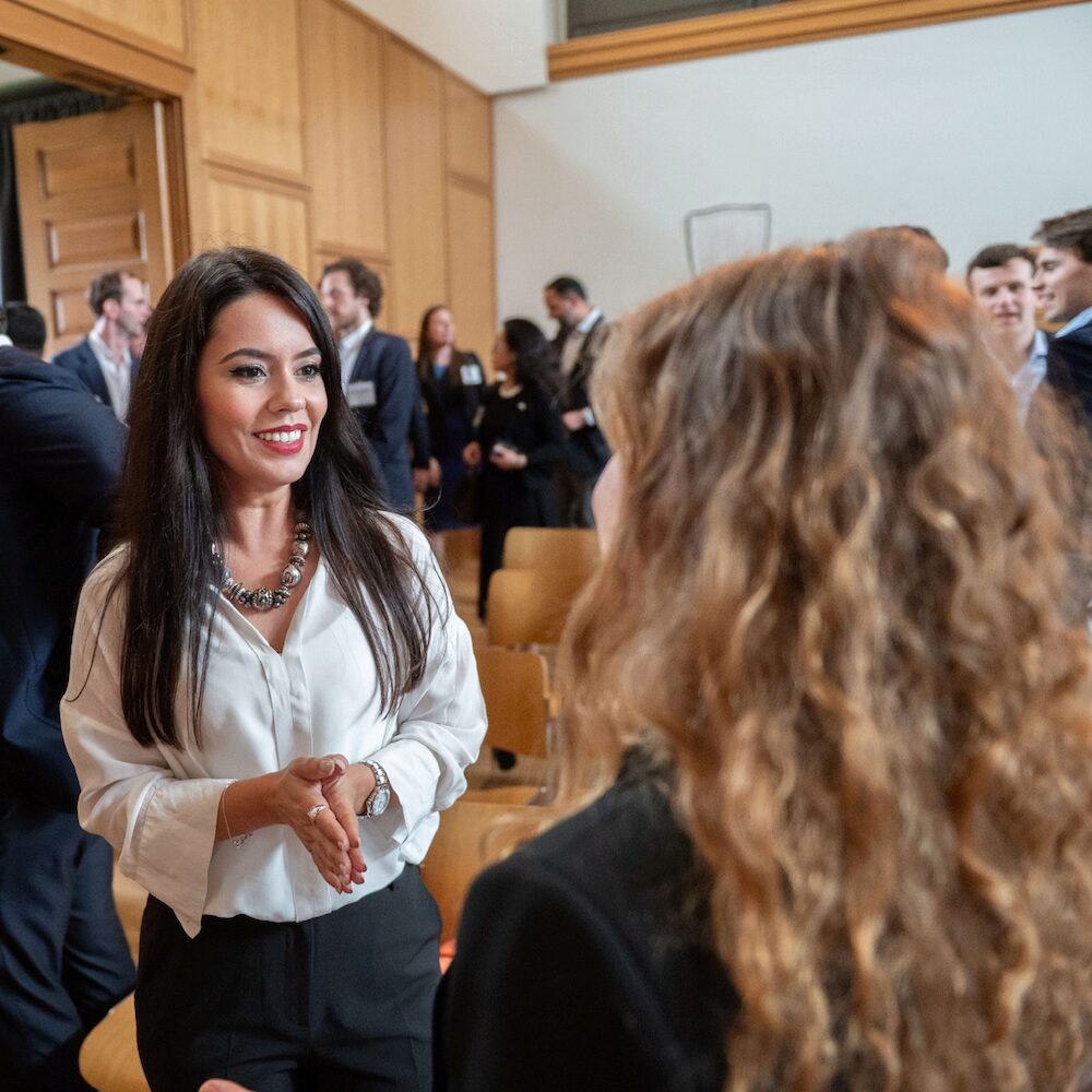 People speaking and networking at an event