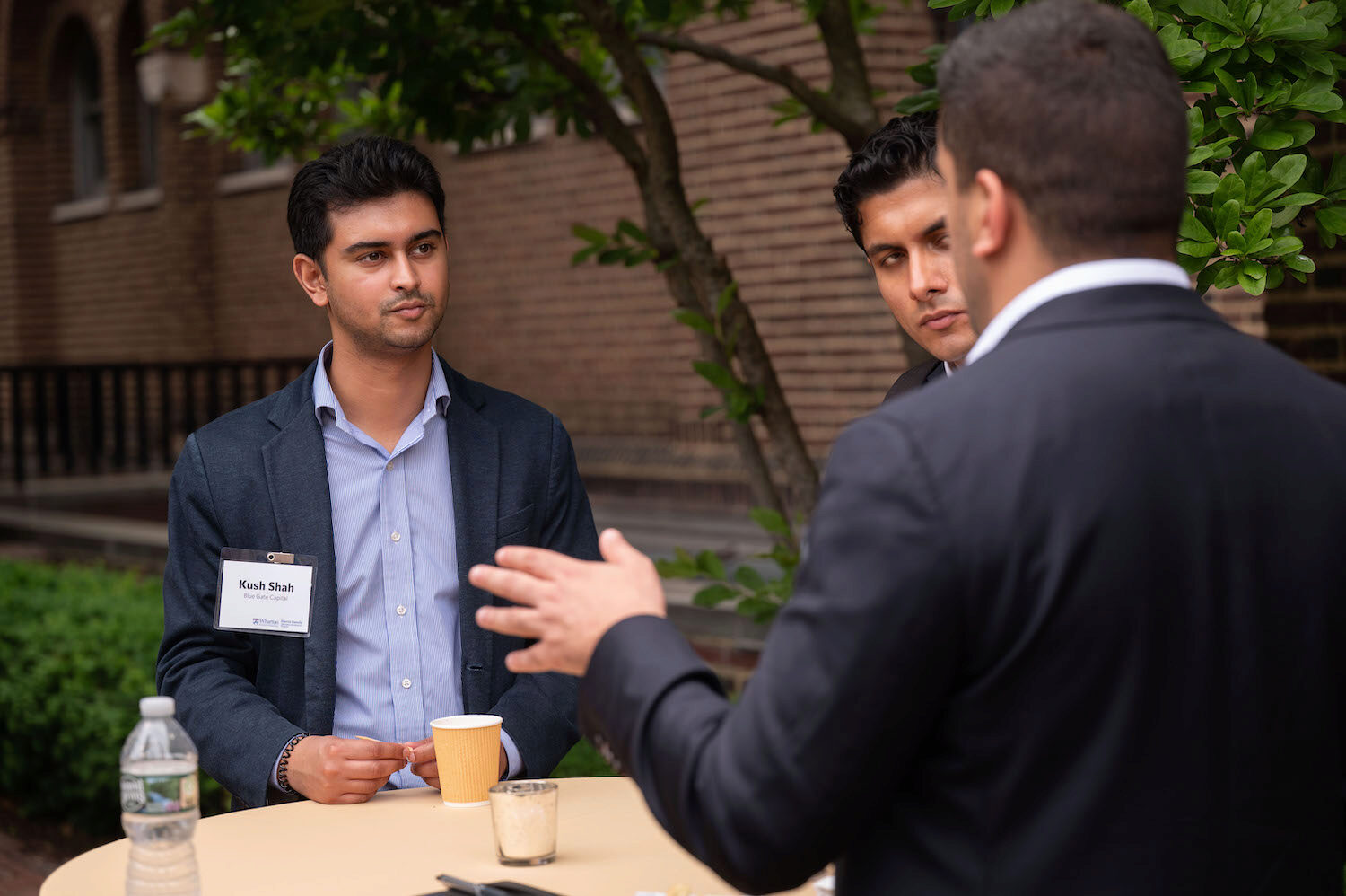 Three people in conversation at a table