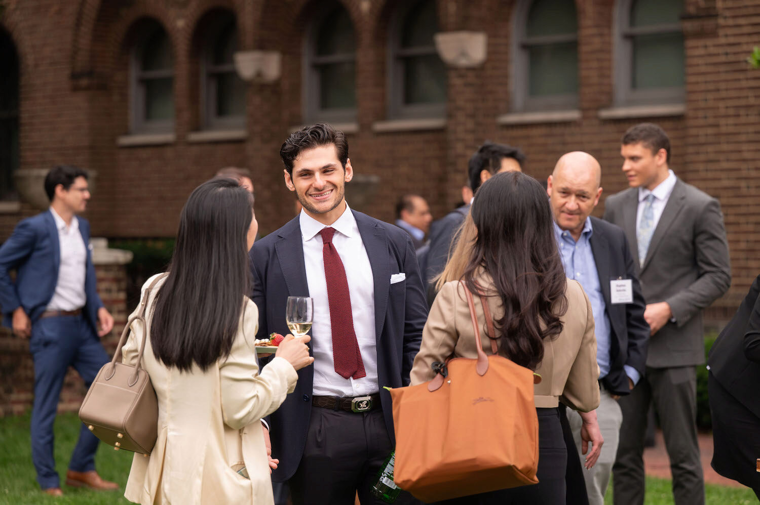 A crowd of people outside, networking