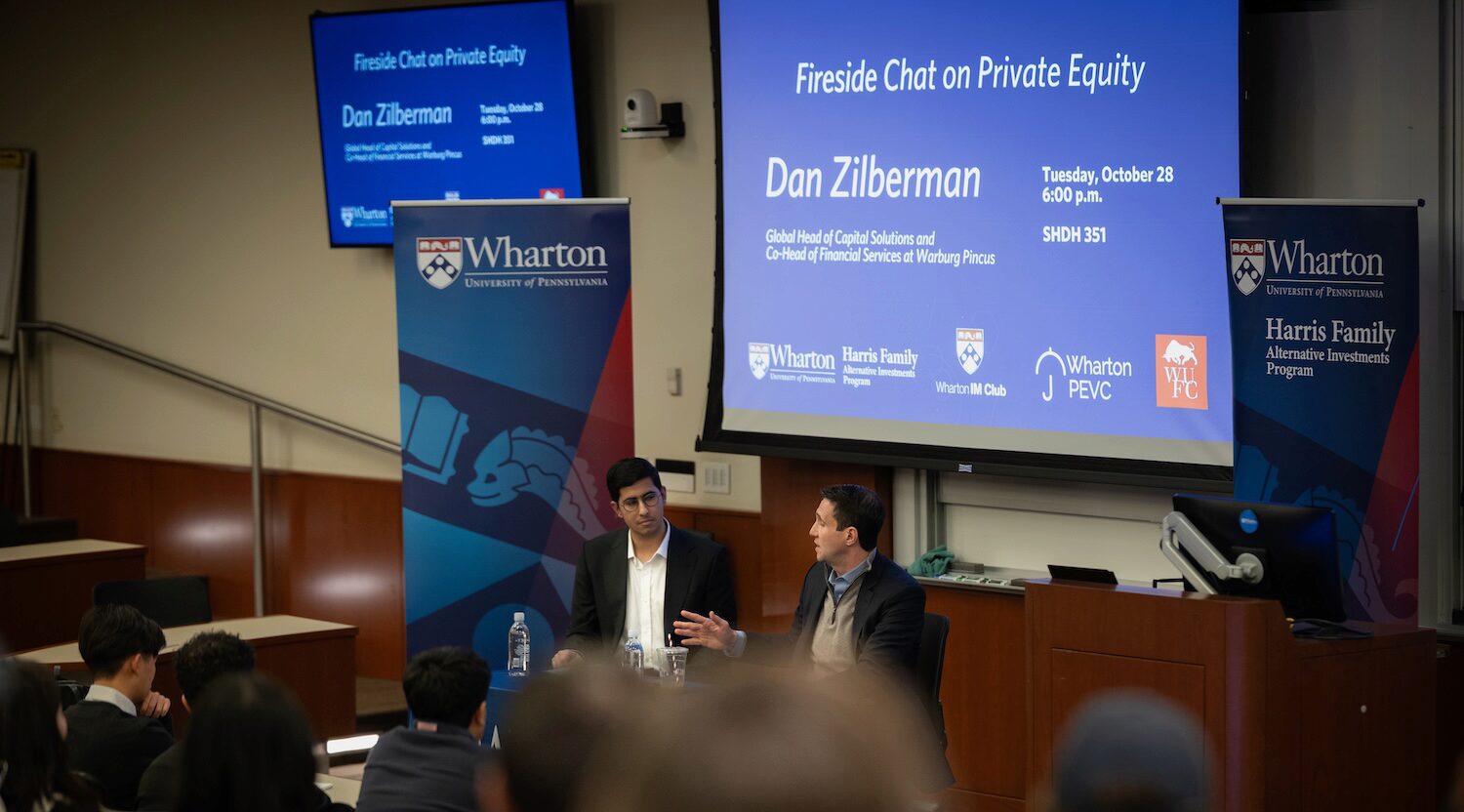 Two speakers engaged in a fireside chat