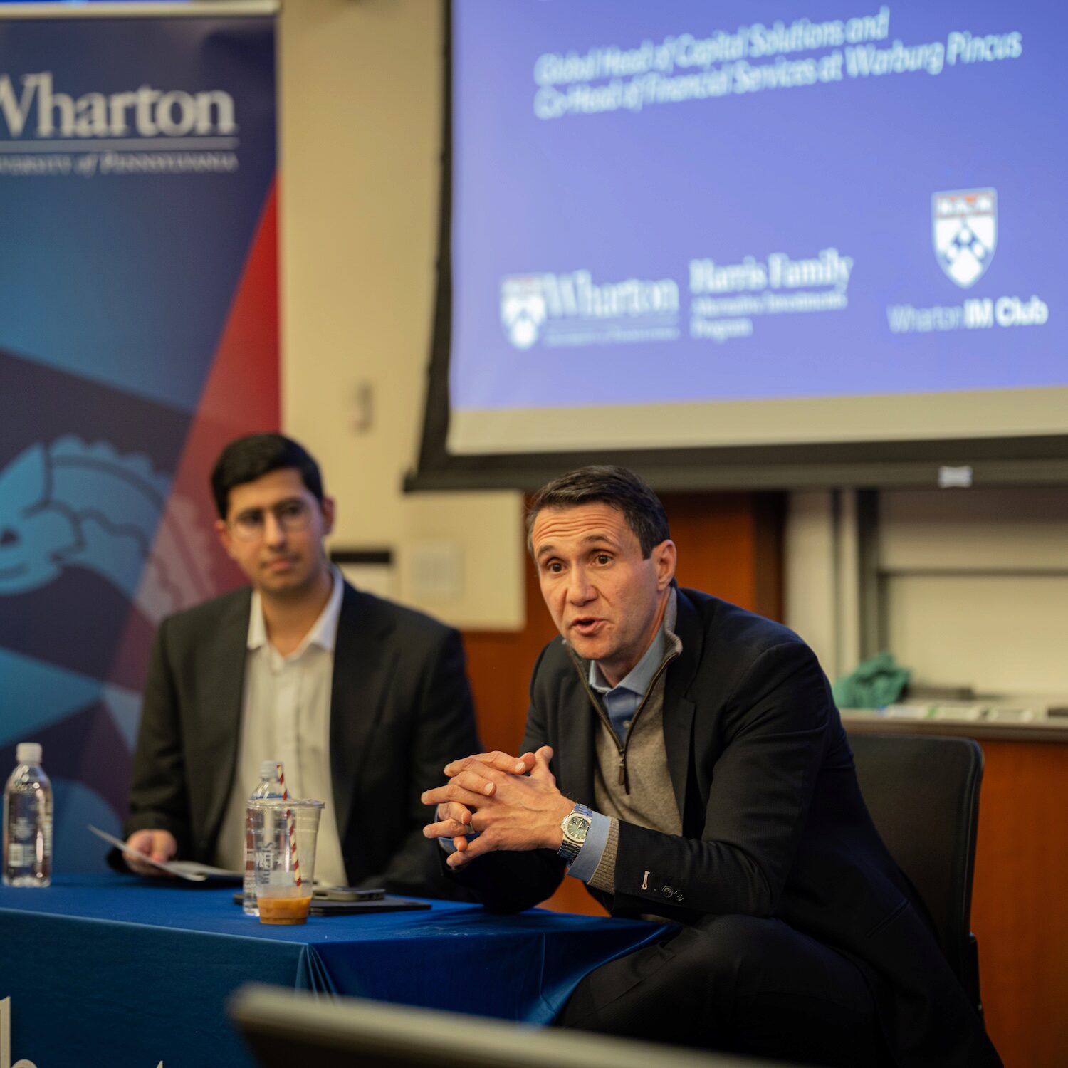 Two speakers engaged in a fireside chat